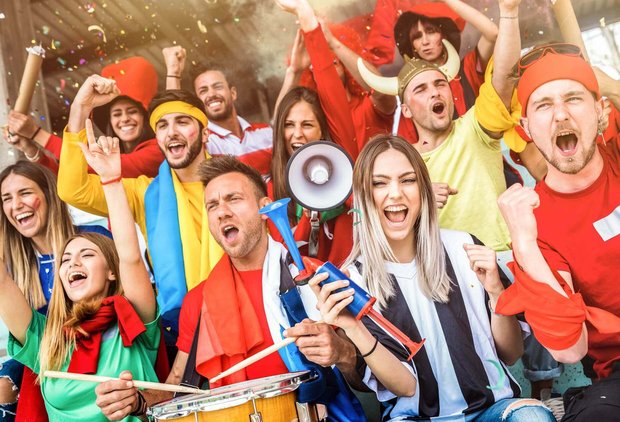 Football supporter fans friends cheering and watching soccer cup match at intenational stadium - Young people group with multicolored t-shirts having excited fun on sport world championship concept. Von Mirko - Adobe Photo Stock